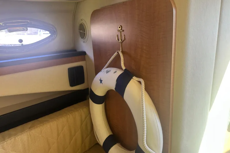 Slide: The Image of Interior of 2006 Sea Ray 260 Sundancer with life preserver and porthole window. - 54