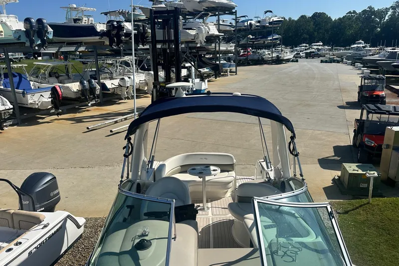 Slide: The Image of 2006 Sea Ray 260 Sundancer in a marina with multiple boats docked. - 57
