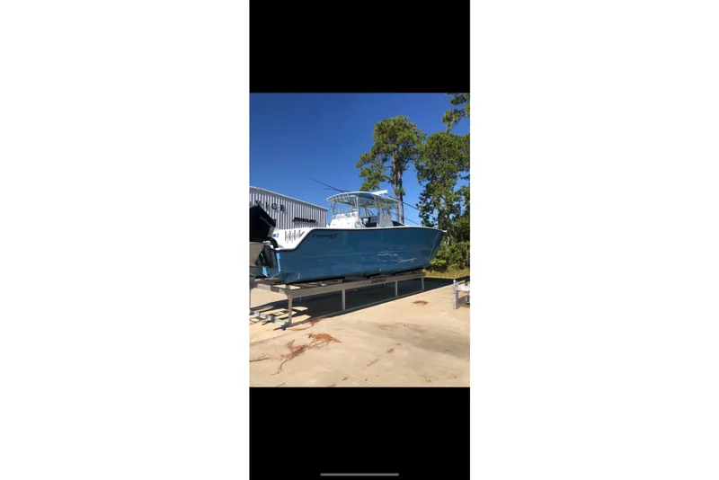 The Image of Freeman 37 VH 2016 boat with Mercury engines docked by the water. - 0