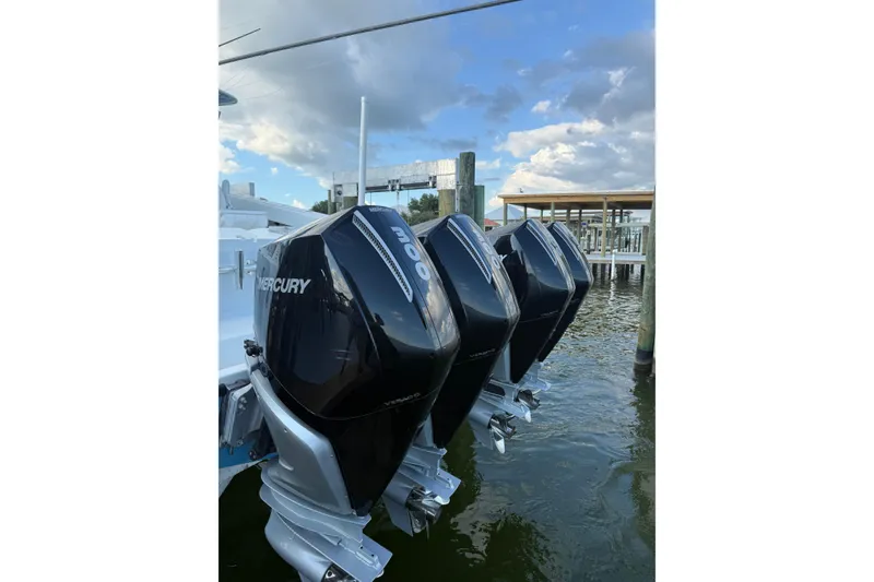 Slide: The Image of Triple Mercury outboard engines on a 2016 Freeman 37 VH boat docked by the water. - 17