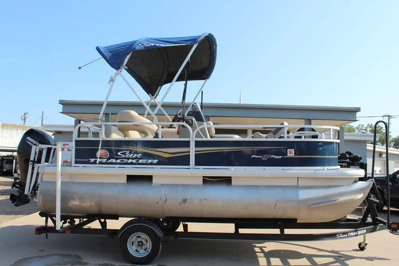 Slide: The Image of 2020 Sun Tracker BASS BUGGY® 16 DLX pontoon boat on trailer, blue canopy. - 3