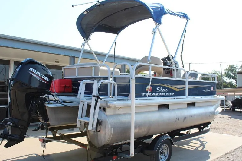 Slide: The Image of 2020 Sun Tracker BASS BUGGY® 16 DLX pontoon boat with Mercury outboard motor on trailer. - 4