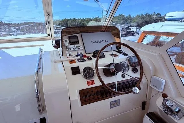 Slide: The Image of 2004 Mainship Pilot 34 helm with Garmin navigation system and classic steering wheel. - 11
