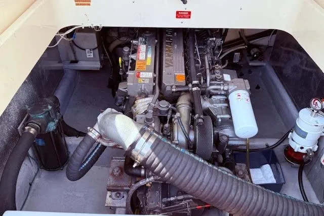 Slide: The Image of Engine compartment of a 2004 Mainship Pilot 34 boat, showcasing mechanical components. - 22