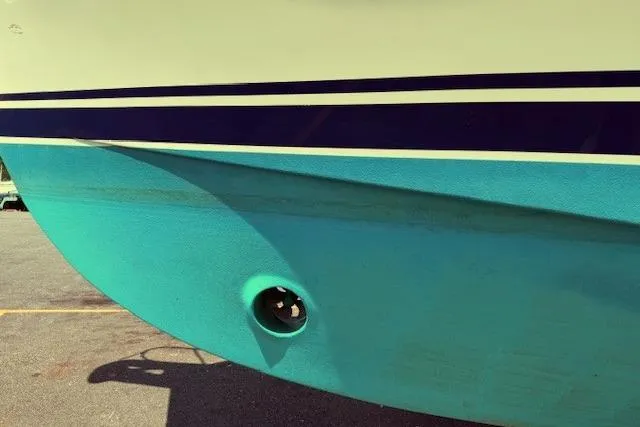 Slide: The Image of 2004 Mainship Pilot 34 boat hull with blue and teal color scheme. - 5