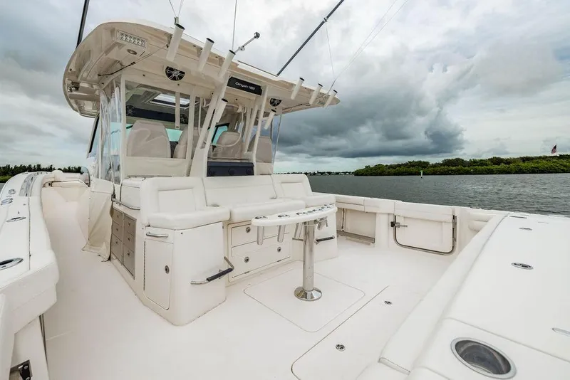 Slide: The Image of 2022 Grady-White Canyon 456 boat interior with seating, under cloudy sky. - 12