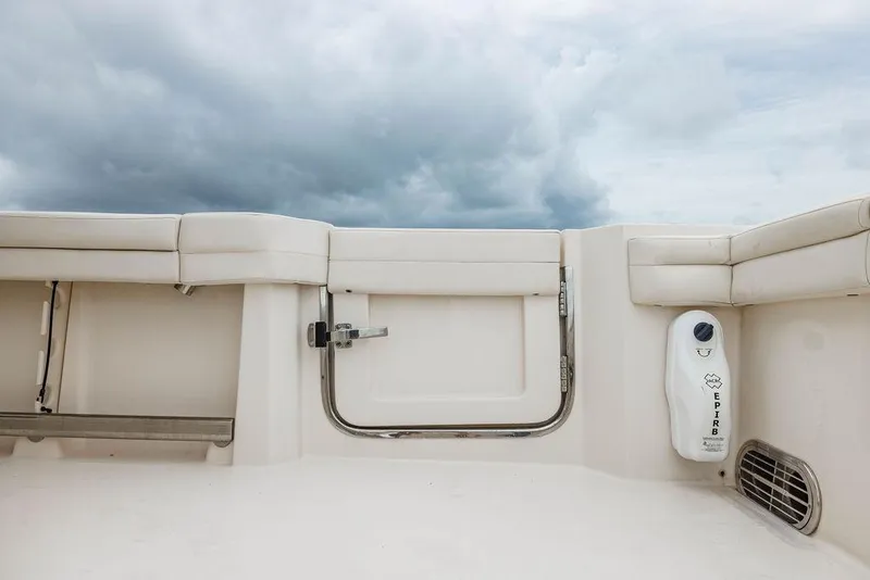 Slide: The Image of 2022 Grady-White Canyon 456 boat interior with white seating and cloudy sky. - 14