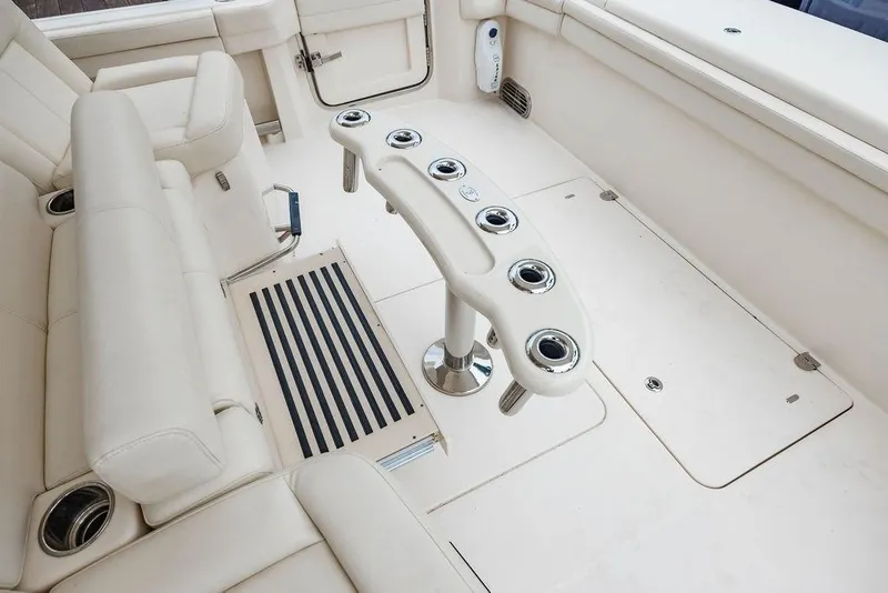 Slide: The Image of 2022 Grady-White Canyon 456 boat interior with rod holders and seating. - 15