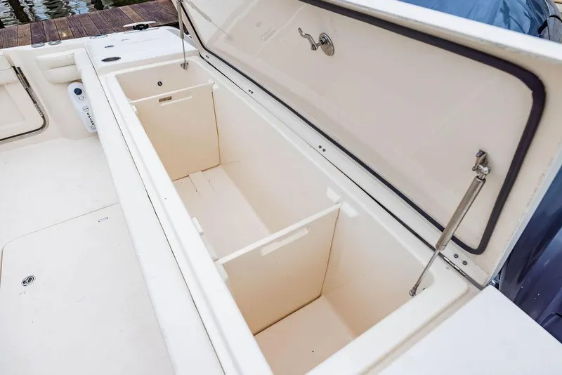 Slide: The Image of Open storage compartment on 2022 Grady-White Canyon 456 boat, showcasing spacious interior. - 16
