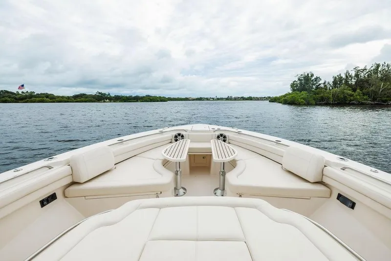 Slide: The Image of 2022 Grady-White Canyon 456 boat interior with seating, on a calm waterway. - 19