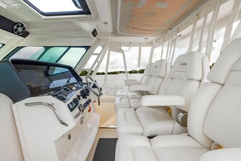 Slide: The Image of 2022 Grady-White Canyon 456 boat interior with luxurious seating and modern helm. - 20