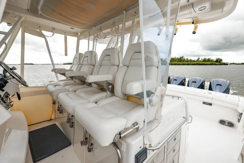 Slide: The Image of 2022 Grady-White Canyon 456 boat interior with luxurious seating and multiple outboard engines. - 23