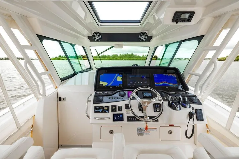 Slide: The Image of Interior view of 2022 Grady-White Canyon 456 boat cockpit with advanced navigation system. - 24