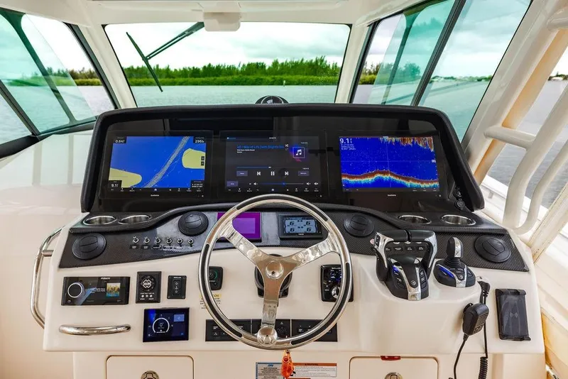 Slide: The Image of Helm of 2022 Grady-White Canyon 456 with advanced navigation and control systems. - 26