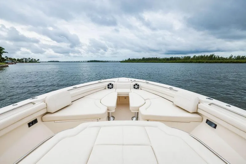 Slide: The Image of 2022 Grady-White Canyon 456 boat interior with plush seating, overlooking serene waters. - 30
