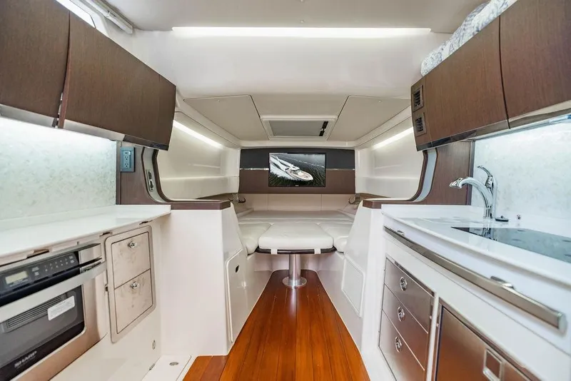 Slide: The Image of Luxurious interior of 2022 Grady-White Canyon 456 boat with modern kitchen and seating area. - 35