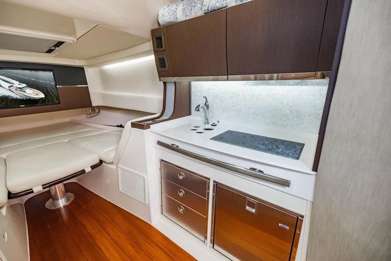 Slide: The Image of Luxurious interior of 2022 Grady-White Canyon 456 boat with kitchenette and seating area. - 37