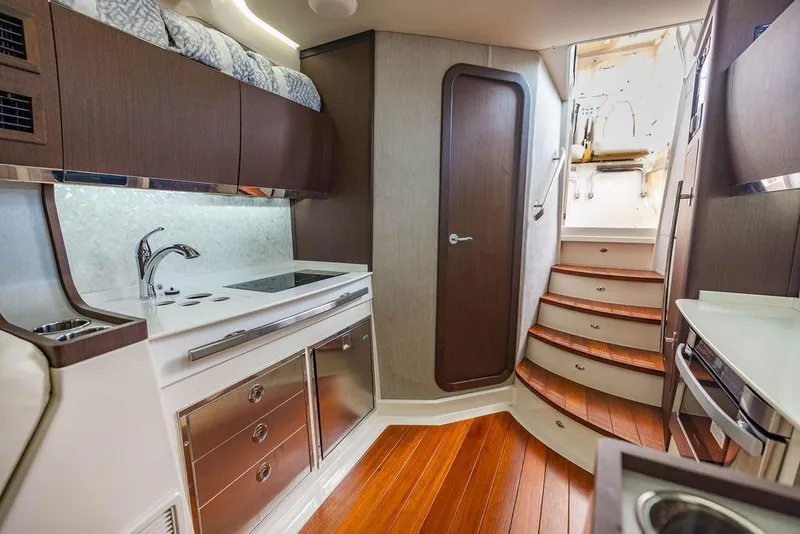 Slide: The Image of Luxurious interior of 2022 Grady-White Canyon 456 boat with modern kitchen and wooden stairs. - 39