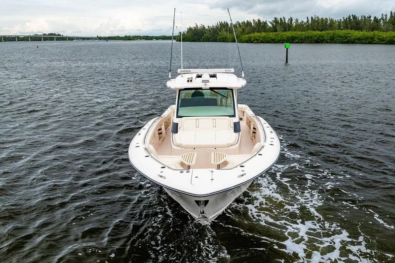 Slide: The Image of 2022 Grady-White Canyon 456 boat cruising on a calm waterway. - 6