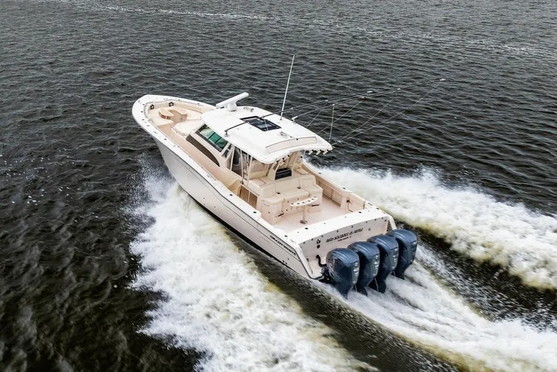 Slide: The Image of 2022 Grady-White Canyon 456 boat cruising on open water, rear view. - 7