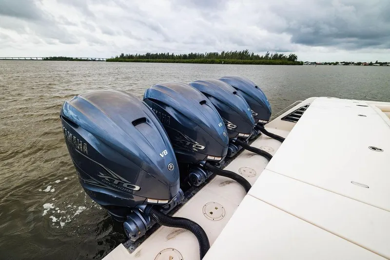 Slide: The Image of Four Yamaha outboard engines on a 2022 Grady-White Canyon 456 boat, on a cloudy day. - 9