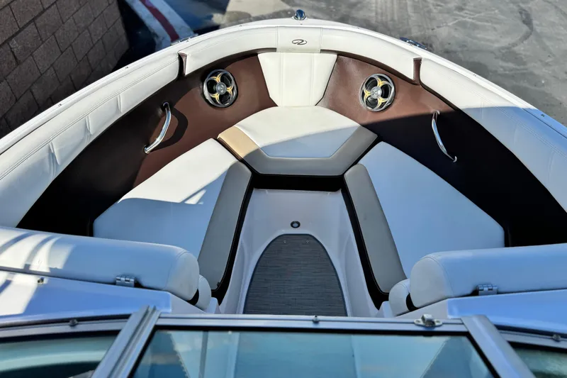 Slide: The Image of Interior of a 2016 Regal 2000 ES boat with white and brown seating. - 10