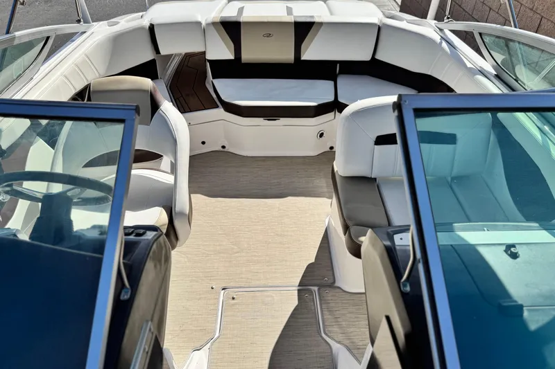 Slide: The Image of Interior of a 2016 Regal 2000 ES boat with white seating and open cockpit. - 13