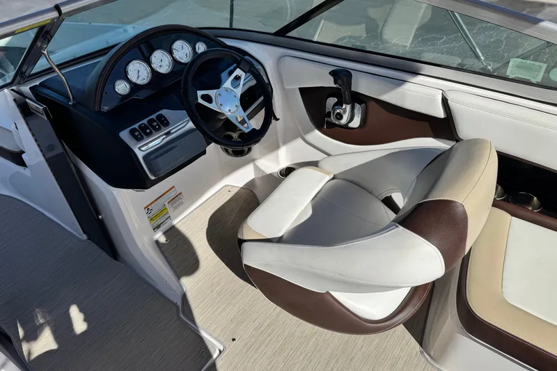 Slide: The Image of Interior of a 2016 Regal 2000 ES boat with steering wheel and gauges. - 22