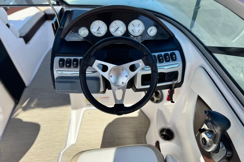 Slide: The Image of 2016 Regal 2000 ES boat dashboard with steering wheel and control panel. - 23