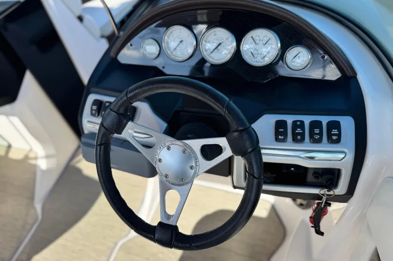 Slide: The Image of Steering wheel and dashboard of a 2016 Regal 2000 ES boat. - 24