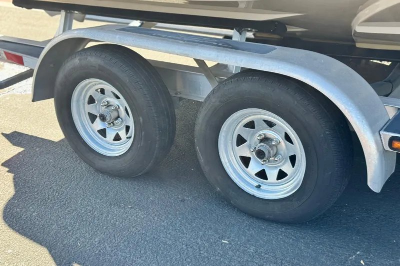 Slide: The Image of Trailer wheels of a 2016 Regal 2000 ES on asphalt pavement. - 25