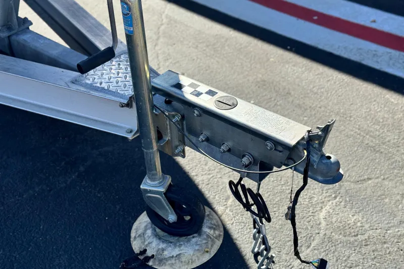 Slide: The Image of Trailer hitch and jack stand of a 2016 Regal 2000 ES on asphalt. - 26