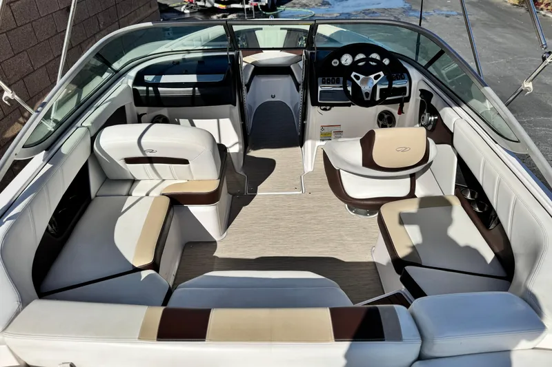 Slide: The Image of Interior of a 2016 Regal 2000 ES boat with white and brown seating. - 8