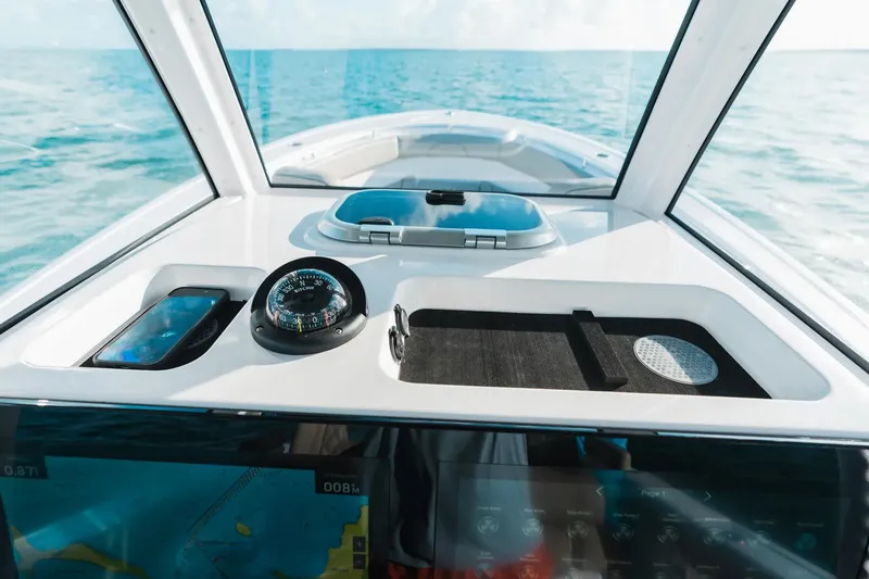 Slide: The Image of 2026 Sportsman Open 282 Center Console dashboard with compass, ocean view. - 12