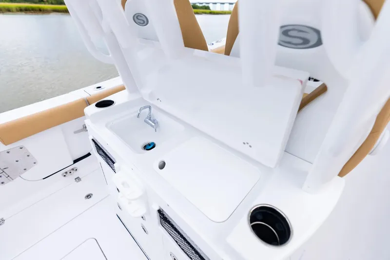 Slide: The Image of 2026 Sportsman Open 282 Center Console boat interior with sink and seating. - 17