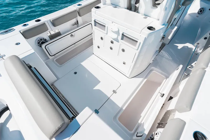 Slide: The Image of 2026 Sportsman Open 282 Center Console boat interior with storage compartments and seating. - 20