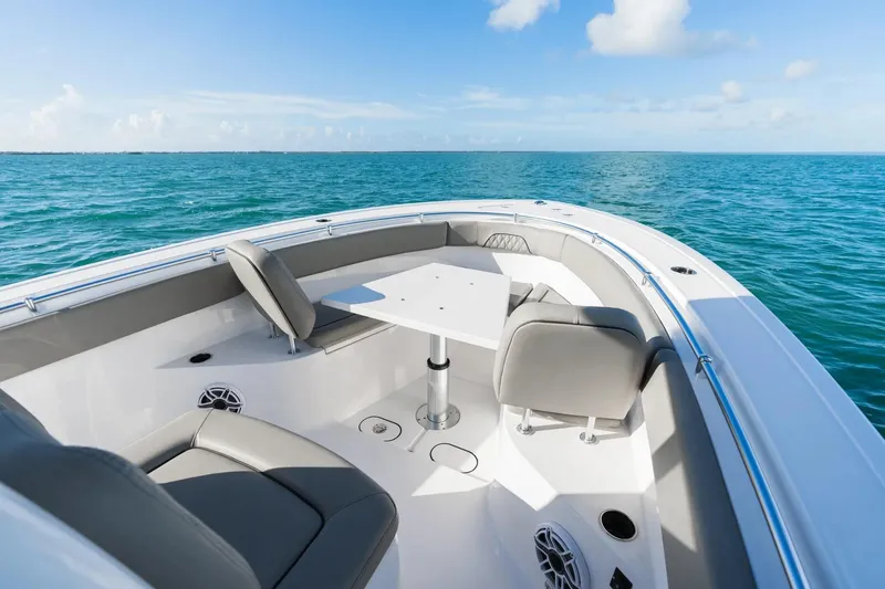 Slide: The Image of 2026 Sportsman Open 282 Center Console boat interior with seating and table on open water. - 3