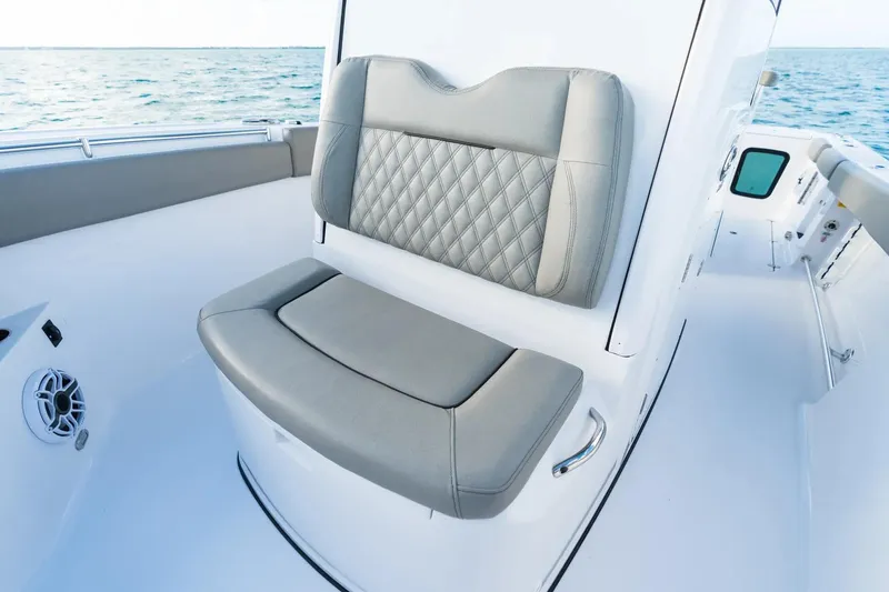 Slide: The Image of 2026 Sportsman Open 282 Center Console boat interior with cushioned seating and ocean view. - 4