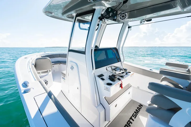 Slide: The Image of 2026 Sportsman Open 282 Center Console boat on clear blue water. - 8