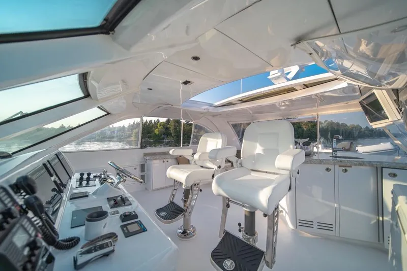 Slide: The Image of Luxurious interior of a 2008 Hatteras 72 Motor Yacht with modern helm and seating. - 11