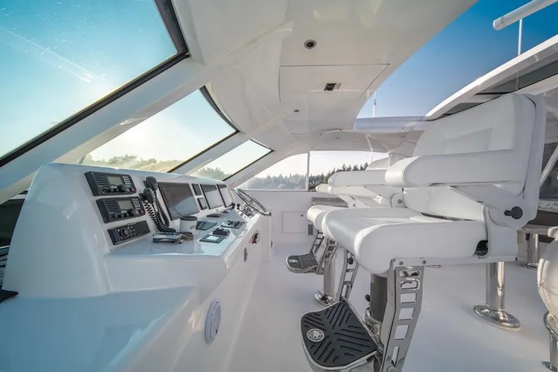 Slide: The Image of Helm of 2008 Hatteras 72 Motor Yacht with modern controls and seating. - 12