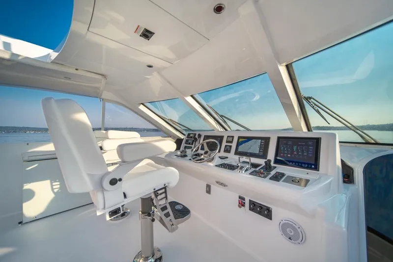 Slide: The Image of Helm of 2008 Hatteras 72 Motor Yacht with modern navigation equipment and white captain's chair. - 14
