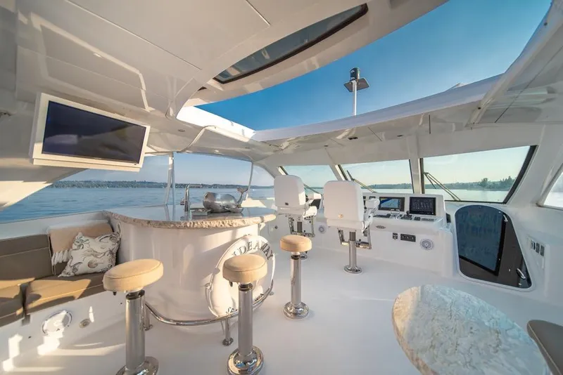 Slide: The Image of Luxurious 2008 Hatteras 72 Motor Yacht interior with bar, seating, and navigation area. - 15