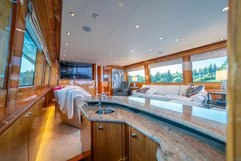 Slide: The Image of Luxurious interior of 2008 Hatteras 72 Motor Yacht with elegant wood finishes and spacious seating. - 23