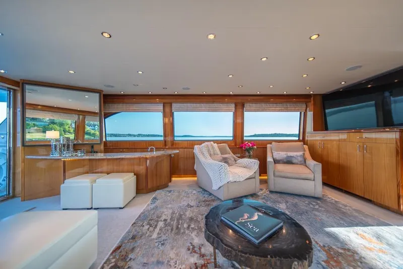 Slide: The Image of Luxurious interior of 2008 Hatteras 72 Motor Yacht with elegant seating and panoramic windows. - 24