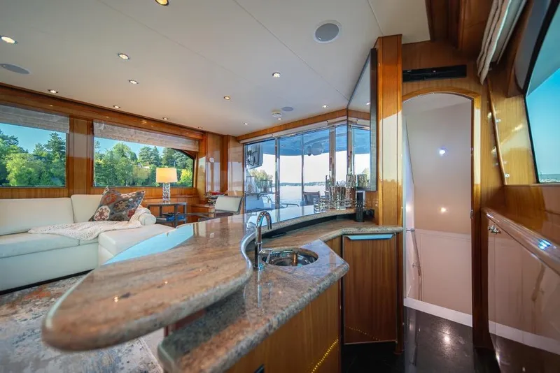 Slide: The Image of Luxurious interior of 2008 Hatteras 72 Motor Yacht with elegant furnishings and panoramic windows. - 26