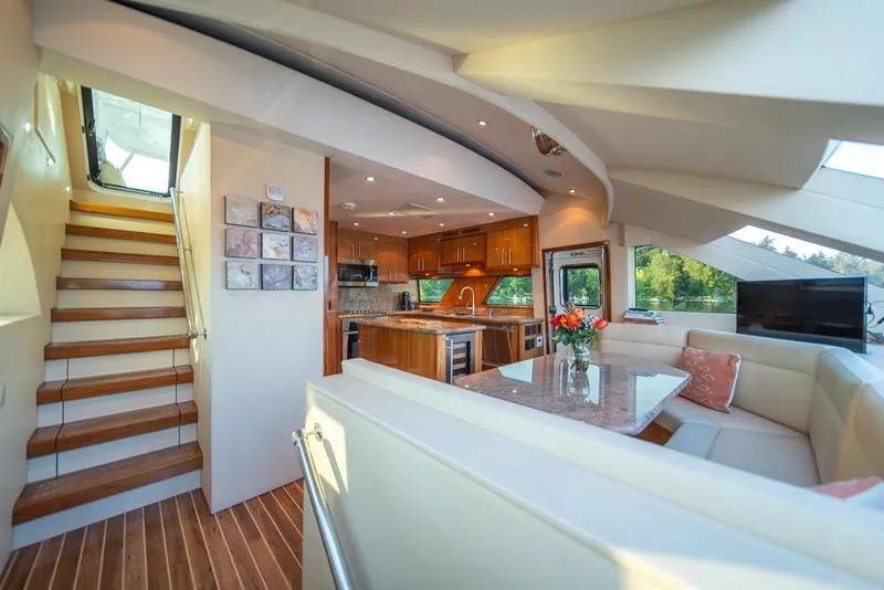 Slide: The Image of Luxurious interior of a 2008 Hatteras 72 Motor Yacht with elegant dining area and modern kitchen. - 28