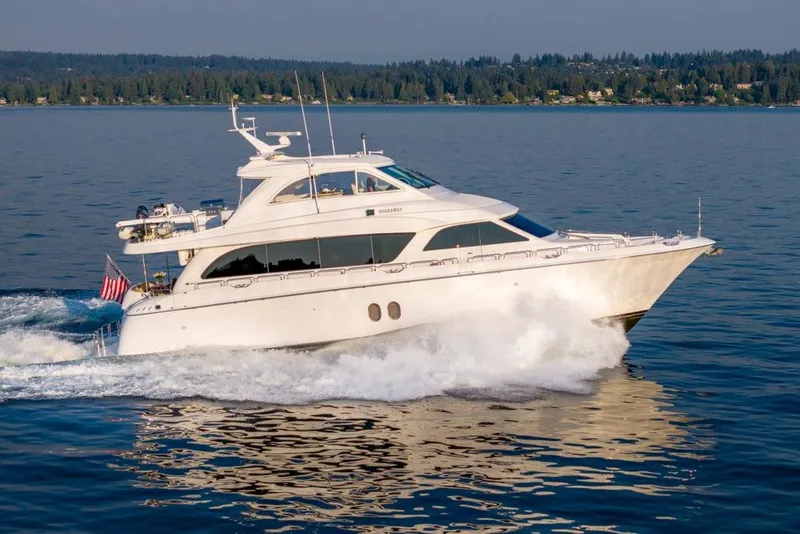 Slide: The Image of 2008 Hatteras 72 Motor Yacht cruising on a serene lake. - 3