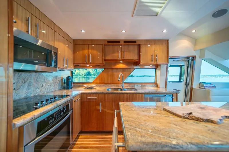 Slide: The Image of Luxurious kitchen interior of 2008 Hatteras 72 Motor Yacht with modern appliances and wood cabinetry. - 31