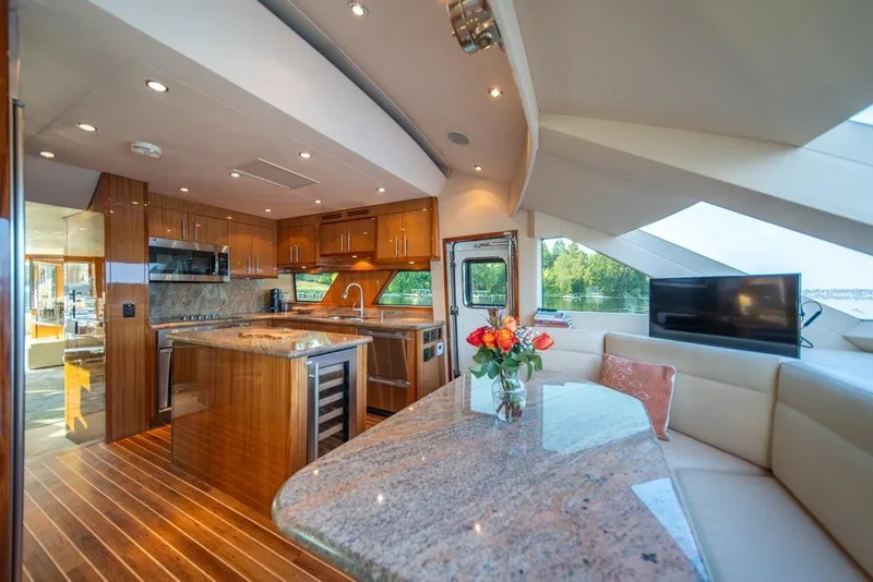 Slide: The Image of Luxurious interior of 2008 Hatteras 72 Motor Yacht with modern kitchen and elegant seating area. - 33